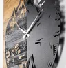 A close-up shot of a wall clock with a mountain and tree silhouette design. Voir les images du produit