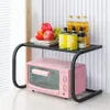 A black metal shelf unit with a pink mini oven on the bottom shelf and various food items and bottles on the top shelf. Náhľad obrázku produktu