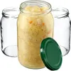 Three glass jars, one filled with sauerkraut, and a green lid. Podgląd zdjęcia produktu