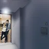 A couple stands in a hallway, looking at each other. Voir les images du produit