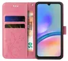 A pink flip phone case with floral and butterfly embossing, showing card slots and a banknote, with a smartphone inside. Produktbild-Vorschau