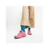 A person wearing pink Skechers Bobs Squad Chaos-Face Off sneakers and blue socks, with beige flared pants, against a white background. Anteprima dell’immagine prodotto