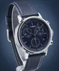 A close-up studio shot of a Timex chronograph watch with a blue dial and a blue leather strap, presented against a gradient blue background. Podgląd zdjęcia produktu