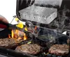 Burgers are being grilled on a barbecue with a smoker box on top, producing smoke. Produktbild-Vorschau