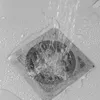 Water flowing into a shower drain with a mesh cover. Podgląd zdjęcia produktu