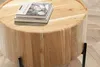 A close-up shot of a round wooden coffee table with two books on top, placed on a herringbone patterned floor. Produktbild-Vorschau