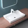 A white ceramic sink with a modern faucet sits on a wooden countertop, with a lit mirror in the background. Produktbild-Vorschau