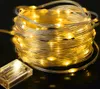 A coiled string of warm white LED lights with a clear battery pack. Produktbild-Vorschau