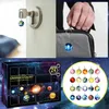 Collage of images showing planet-themed keychains, an advent calendar, and a close-up of planet charms. Náhled obrázku produktu