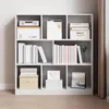 A white bookshelf filled with books and decorative boxes. Podgląd zdjęcia produktu