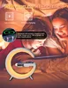 Two children are in bed, looking at a tablet. A bedside lamp with a wireless charger and clock is in the foreground. Produktbild-Vorschau