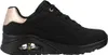 A side view of a black Skechers sneaker with rose gold accents. Voir les images du produit