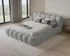 A modern bedroom with a large, plush bed. Voir les images du produit