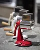 Three manual graters are lined up on a counter. Produktbild-Vorschau