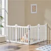 A dog is inside a white wooden pet gate in a room with a window and a framed picture on the wall. Podgląd zdjęcia produktu