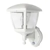 A white outdoor wall lamp with a clear glass enclosure and a visible light bulb, mounted on a white wall. Produktbild-Vorschau
