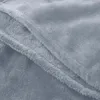 A close-up view of a soft, light blue blanket, showing its texture and folded layers. Produktbild-Vorschau