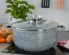 A speckled gray pot with a glass lid sits on a black stovetop, with potatoes and carrots to the left and a plant in the background. Náhľad obrázku produktu