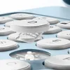 A close-up view of a light blue keyboard with white circular keys. One key is slightly raised, revealing a white mechanical support structure underneath. Náhled obrázku produktu