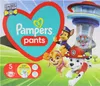 The image shows a package of Pampers Pants diapers featuring characters from Paw Patrol. The package has a large heart shape with the Pampers logo and text. Several Paw Patrol characters are depicted in the foreground. Podgląd zdjęcia produktu