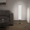 A floor lamp is shown next to a sofa in a living room setting. Náhľad obrázku produktu