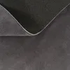 A close-up view of the underside and edge of a gray rug, showing the texture of the fabric and the anti-slip backing. Produktbild-Vorschau