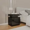 A black high-gloss nightstand next to a bed. Produktbild-Vorschau