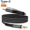 A black USB-C to 3.5mm audio cable coiled on a white background. Produktbild-Vorschau