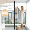 A woman is hanging clothes on a telescopic garment rack on a balcony. Produktbild-Vorschau