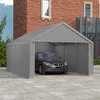 A grey car is parked inside a grey tent garage structure, with a brick building in the background. Náhled obrázku produktu