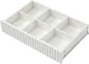 An empty white drawer organizer with six compartments, shown from a slightly elevated angle. Podgląd zdjęcia produktu