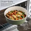 A pot of food with shrimp and vegetables is placed on an oven rack inside an oven. Produktbild-Vorschau