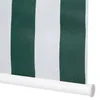 A close-up view of a green and white striped roller blind with a white bottom bar. Voir les images du produit