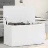 A white storage chest with its lid open, revealing pillows inside, placed in a bedroom setting next to a bed. Náhľad obrázku produktu