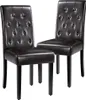 Two dark brown upholstered dining chairs with tufted backs and dark wooden legs are shown against a white background. Produktbild-Vorschau