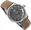 A close-up shot of an Orient watch with a gray dial and a brown strap. Voir les images du produit