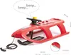 A red plastic sled with a steering wheel and a tow rope, shown on a white background. Produktbild-Vorschau