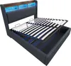 A bed frame with the mattress support lifted to reveal storage space underneath. The headboard has integrated LED lighting. Anteprima dell’immagine prodotto