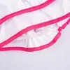 A close-up view of the edge of a white apron with pink trim, showing the elasticated waist and ruffled hem. Produktbild-Vorschau