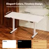 A white standing desk with dimensions labeled, shown in a home or office setting with wooden flooring and plants. Produktbild-Vorschau