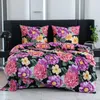 A bed with floral bedding in a bedroom setting. Produktbild-Vorschau