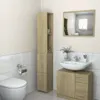 A bathroom scene with a toilet, sink, cabinet, and tall storage unit. Podgląd zdjęcia produktu