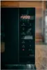 Close-up of a black microwave control panel with a digital display showing the time. Anteprima dell’immagine prodotto