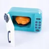 A toy microwave with a toy chicken inside, with the door open. Produktbild-Vorschau