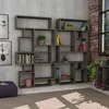 A modern living room with a large, modular bookshelf filled with books and decorative items, next to a window with a brick wall. Produktbild-Vorschau
