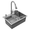 A stainless steel kitchen sink with a faucet, soap dispenser, and dish rack. Podgląd zdjęcia produktu