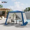 A blue and white gazebo with furniture set up next to a swimming pool. Produktbild-Vorschau
