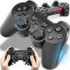 Two black wireless game controllers are shown, with one being held by a pair of hands in the foreground. Podgląd zdjęcia produktu