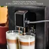 A close-up shot of a KRUPS coffee machine dispensing cappuccinos into two glasses. Voir les images du produit