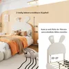 A child's bed with a rabbit-shaped headboard, shown in a bedroom setting and with a close-up detail of the headboard height adjustment. Produktbild-Vorschau